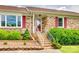 Close-up of the front entrance with red door, white railing, and landscaping at 3903 Graywood Dr, Gastonia, NC 28052