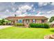 Charming brick home featuring a well-manicured lawn, red shutters, and a covered carport at 3903 Graywood Dr, Gastonia, NC 28052