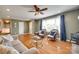 Comfortable living room featuring hardwood floors, ceiling fan, and a large window at 3903 Graywood Dr, Gastonia, NC 28052