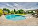 A pristine swimming pool surrounded by lush greenery, a well-maintained pool deck, and lounge chairs at 3903 Graywood Dr, Gastonia, NC 28052