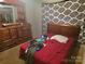 Bedroom with a bed, wooden furniture and patterned black and white sheet at 424 Congress S St, York, SC 29745