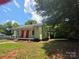 Exterior view of home and yard surrounded by mature trees at 424 Congress S St, York, SC 29745