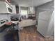 Kitchen area featuring white cabinets and a refrigerator at 424 Congress S St, York, SC 29745