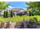 Spacious backyard features a patio with outdoor seating, a lush lawn, and mature trees and landscaping at 5064 Lassen Volcanic Trl, Lancaster, SC 29720