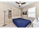 Cozy bedroom with a blue murphy bed, built-in shelving, and a window with shutters at 5064 Lassen Volcanic Trl, Lancaster, SC 29720