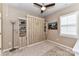 Cozy bedroom featuring a stylish Murphy bed flanked by shelving units and neutral decor at 5064 Lassen Volcanic Trl, Lancaster, SC 29720