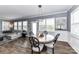 Dining area showcases a round table with stylish chairs, modern light fixture, wainscoting, and seamless flow to the living room at 5064 Lassen Volcanic Trl, Lancaster, SC 29720