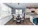 The dining area is bathed in natural light from multiple windows and seamlessly connected to the modern, well-equipped kitchen at 5064 Lassen Volcanic Trl, Lancaster, SC 29720