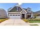 Charming two-story home with a two-car garage, well-manicured landscaping, and a spacious driveway at 5064 Lassen Volcanic Trl, Lancaster, SC 29720