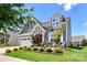 Charming two-story home featuring manicured landscaping, a two-car garage, and inviting front porch area at 5064 Lassen Volcanic Trl, Lancaster, SC 29720