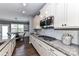 Gourmet kitchen features sleek white cabinetry, granite countertops, tile backsplash and stainless steel appliances for modern appeal at 5064 Lassen Volcanic Trl, Lancaster, SC 29720