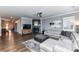 Spacious living room with a fireplace, mounted TV, sectional sofa, and stylish decor, creates a warm and inviting atmosphere at 5064 Lassen Volcanic Trl, Lancaster, SC 29720