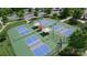 Aerial view of community pickleball courts with shaded seating areas and beautiful landscaping at 5064 Lassen Volcanic Trl, Lancaster, SC 29720