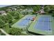 Aerial view of well-maintained tennis courts surrounded by lush greenery in a community at 5064 Lassen Volcanic Trl, Lancaster, SC 29720