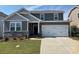 Charming two-story home featuring a two-car garage, stone accents, and well-maintained lawn at 565 Mountain View Dr, Monroe, NC 28110