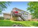 Expansive backyard with a deck, fire pit, and lush greenery, perfect for outdoor activities at 5832 Lagrande Dr, Charlotte, NC 28269