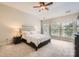 Cozy bedroom featuring plush carpet, a ceiling fan, and three large windows for plenty of natural light at 5832 Lagrande Dr, Charlotte, NC 28269