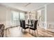 Elegant dining room with modern lighting, large windows, and stylish seating, perfect for gatherings at 5832 Lagrande Dr, Charlotte, NC 28269
