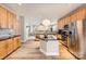 Open kitchen with island, granite counters, and stainless appliances that offers seamless flow into the adjacent living spaces at 5832 Lagrande Dr, Charlotte, NC 28269