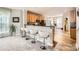 Kitchen with counter seating and stainless steel appliances that seamlessly flows into an adjacent living space at 5832 Lagrande Dr, Charlotte, NC 28269