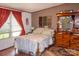 Bedroom with hardwood floors, a queen bed, and ample natural light from a large window at 6213 Golden Oak Ln, Denver, NC 28037