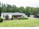 Well-maintained home featuring a covered front porch, manicured lawn, and ample parking at 6213 Golden Oak Ln, Denver, NC 28037