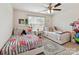Shared bedroom with ceiling fan and two twin beds with floral accents at 8035 Pastime Ln, Clover, SC 29710