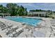 Community pool with swimming lanes, several people swimming and lounging, and a recreational building in the background at 8035 Pastime Ln, Clover, SC 29710