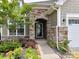 Inviting entryway featuring a stone archway, well-maintained landscaping, and a welcoming front door at 8035 Pastime Ln, Clover, SC 29710