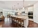 Open-concept kitchen with a large island, seating, and seamless flow into the dining area at 8035 Pastime Ln, Clover, SC 29710