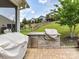 Outdoor kitchen area featuring stone counter, built-in grill, and hardscaped patio for entertaining at 8035 Pastime Ln, Clover, SC 29710