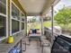 Relaxing screened porch with outdoor seating and green backyard views at 8035 Pastime Ln, Clover, SC 29710