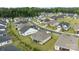 Aerial view of neighborhood, highlighting well-maintained home, lush greenery, and screened-in porch at 82120 Standing Oak Dr, Charlotte, NC 28278