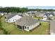 Aerial view of a residential home, backyard and screened-in porch surrounded by lush greenery in neighborhood at 82120 Standing Oak Dr, Charlotte, NC 28278