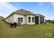 Expansive backyard with green lawn, screened-in porch perfect for outdoor relaxation and entertaining guests at 82120 Standing Oak Dr, Charlotte, NC 28278
