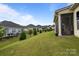 Beautiful landscaped backyard with lush green grass, well-kept lawns, and a screened-in porch for relaxation at 82120 Standing Oak Dr, Charlotte, NC 28278