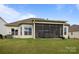 Spacious backyard with lush green lawn and comfortable screened-in porch offering great outdoor living space at 82120 Standing Oak Dr, Charlotte, NC 28278