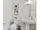 Elegant half bath with pedestal sink, decorative mirror and stylish fixtures at 82120 Standing Oak Dr, Charlotte, NC 28278