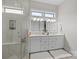 Modern bathroom featuring double vanity, walk-in shower, and bright natural light at 82120 Standing Oak Dr, Charlotte, NC 28278