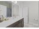 Stylish bathroom with modern vanity, neutral tones and shower with curtain at 82120 Standing Oak Dr, Charlotte, NC 28278