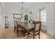 Spacious dining room with a large wooden table, modern chandelier, and lots of natural light at 82120 Standing Oak Dr, Charlotte, NC 28278