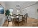 Elegant dining area features a large table, stylish chandelier, and hardwood flooring at 82120 Standing Oak Dr, Charlotte, NC 28278