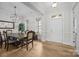 Bright dining room featuring wood floors, modern lighting, and a doorway to welcome guests at 82120 Standing Oak Dr, Charlotte, NC 28278
