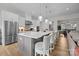 Modern kitchen with stainless steel appliances, pendant lighting, and a large island with bar seating at 82120 Standing Oak Dr, Charlotte, NC 28278