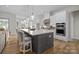 Modern kitchen featuring a large island, stainless steel appliances, and white cabinets at 82120 Standing Oak Dr, Charlotte, NC 28278