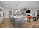 Open-concept kitchen and living area with hardwood floors and fireplace, great for entertaining and relaxation at 82120 Standing Oak Dr, Charlotte, NC 28278