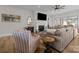 Comfortable living room featuring a fireplace, large windows, and a cozy armchair at 82120 Standing Oak Dr, Charlotte, NC 28278