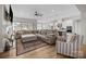 Open-concept living room with hardwood floors, a fireplace, and seamless flow into the kitchen at 82120 Standing Oak Dr, Charlotte, NC 28278