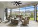 Inviting screened-in porch with comfortable seating, ceiling fan, and view of the backyard at 82120 Standing Oak Dr, Charlotte, NC 28278