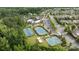 Aerial view of tennis courts, part of the community amenities surrounded by trees and landscaping at 82120 Standing Oak Dr, Charlotte, NC 28278